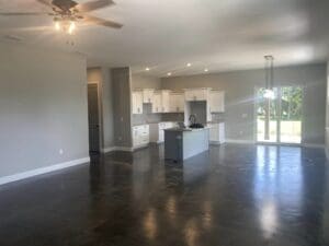 A kitchen with dark floors and white walls.