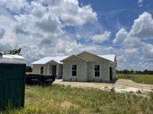 A house that is being built in the dirt.