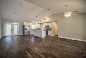 A kitchen with wood floors and white appliances.