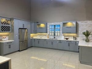 A kitchen with a refrigerator and sink in it