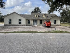 A large house with a red truck parked in front of it.